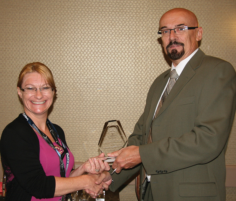 Lisa McPherson receiving her presidential award from RCNA
						President Bret Evans